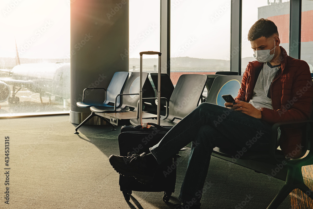 A man waiting at an airline gate